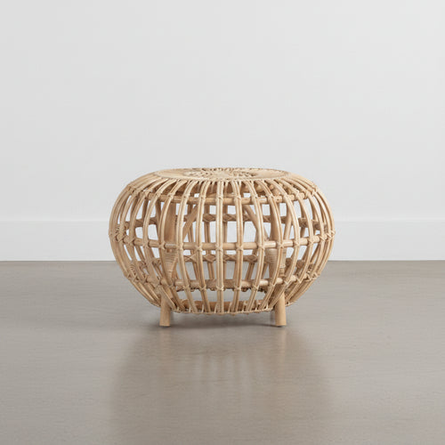 A beige rattan side table with a geometric lattice design and four legs.
